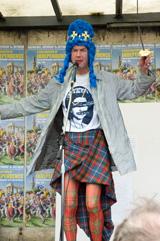 Tam Dean Burns as the Queen